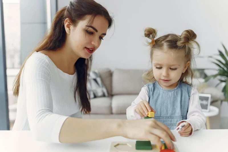 Image showcasing compassionate babysitting services in Qatar by Al Midan Maids Solution. A caring babysitter engages with a happy child, ensuring a safe and nurturing environment.