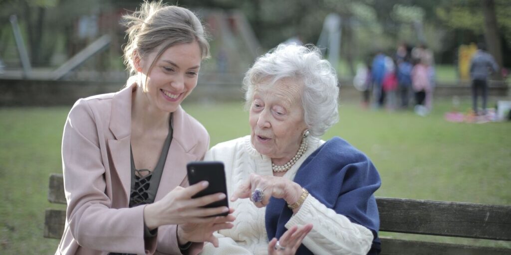 Private caregiver in Qatar explaining and showing something to the patient.